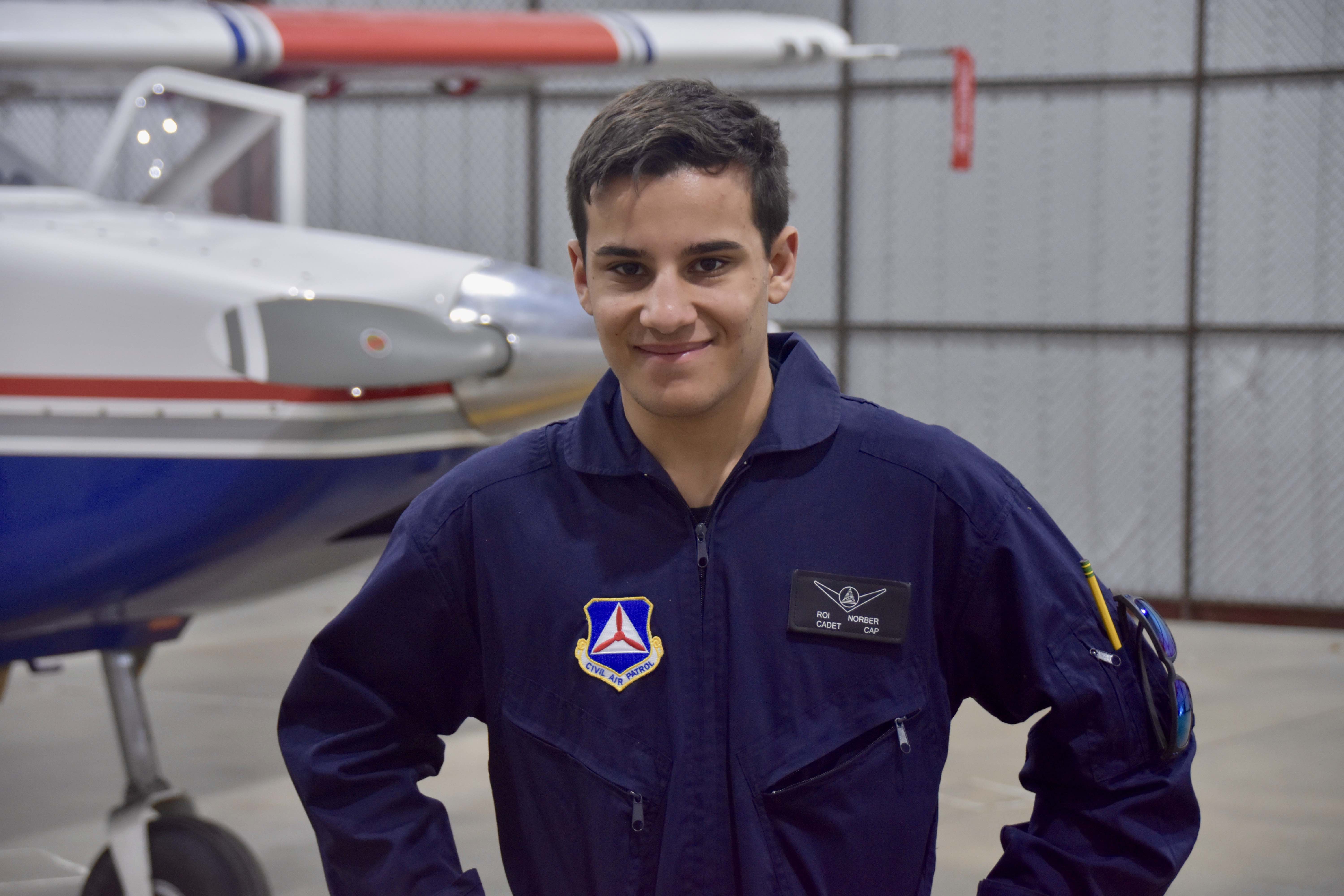 Cadet Norber in a hangar with a CAP plane