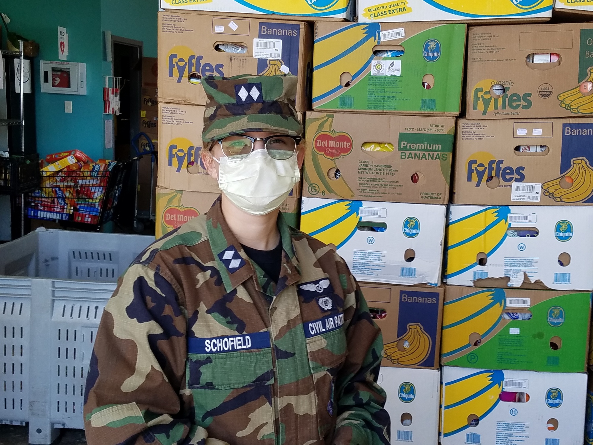 C/Lt col Sara Schofield in front of one of the finished pallets of food boxes Photo credit: Lt Col Gary Gross, Col Shorty Powers Composite Squadron