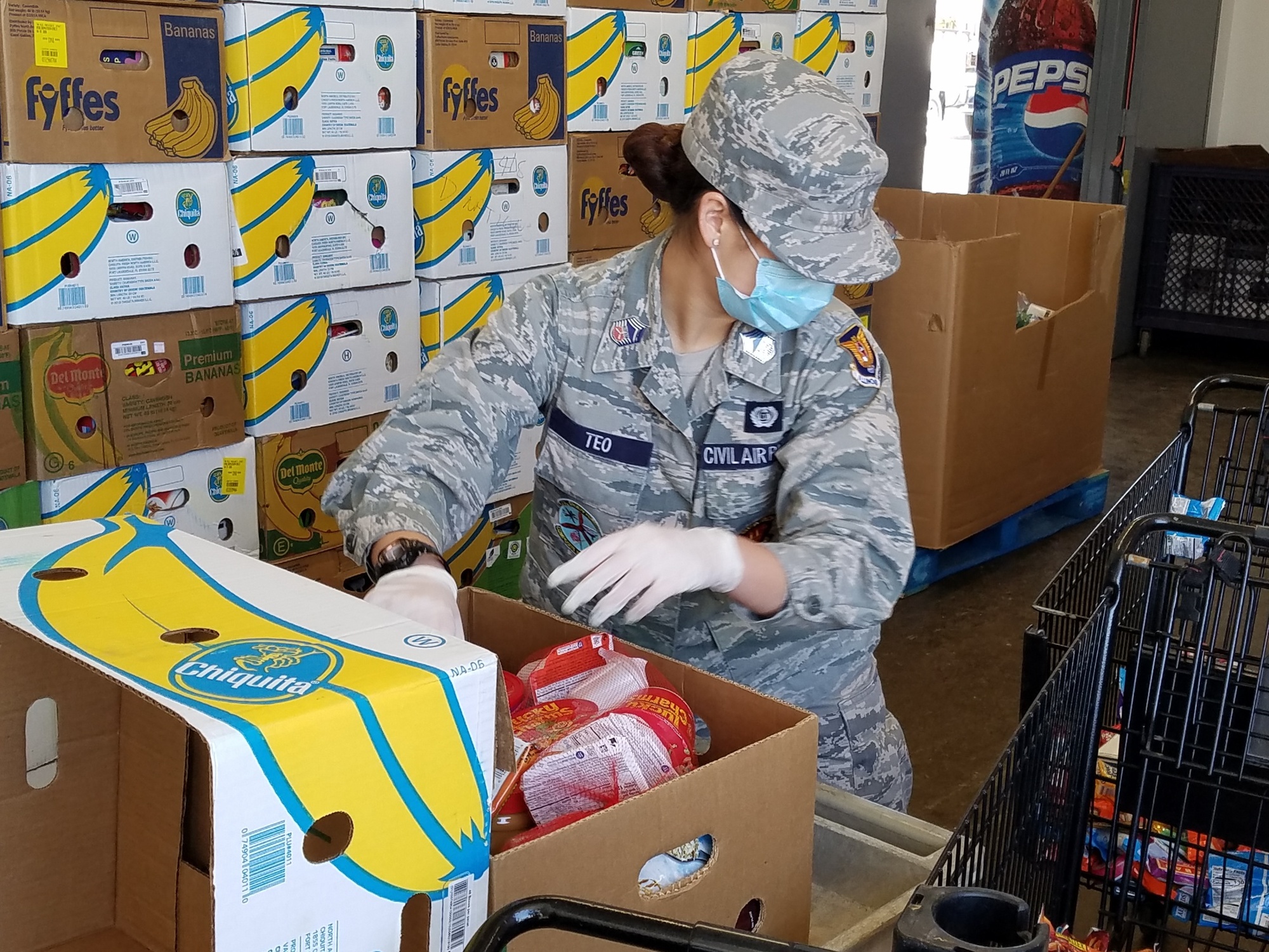 C/CMSgt Emma Teo putting the finishing touches on the food boxes. Photo credit: Lt Col Gary Gross, Col Shorty Powers Composite Squadron